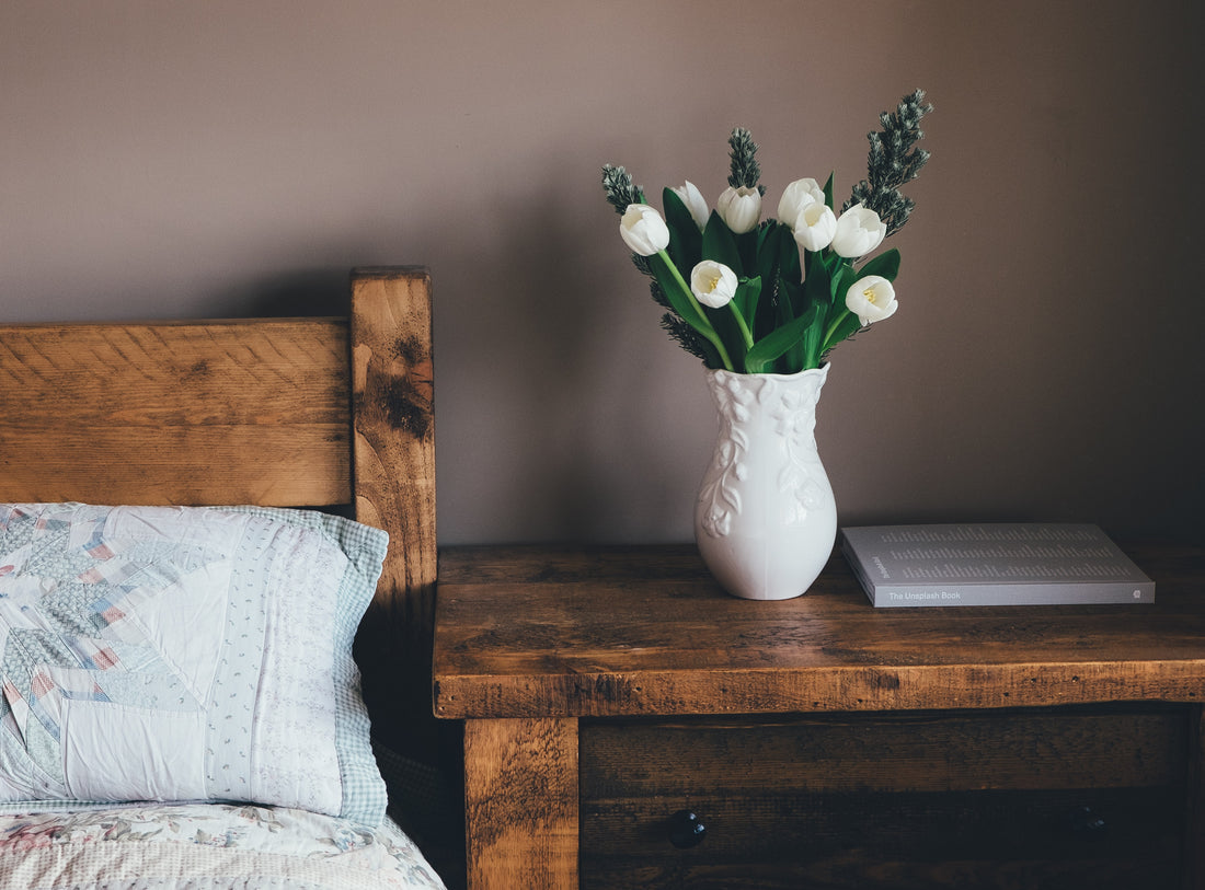 A vase with white flowers on a table